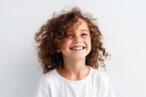 Portrait of a smiling little girl with curly hair on white background