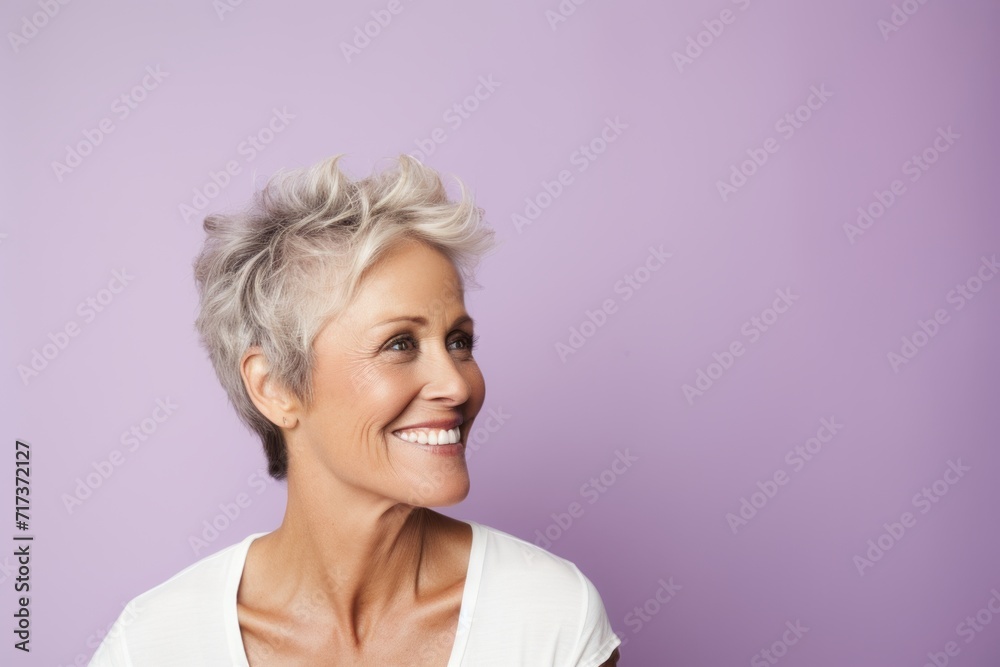 Portrait of a happy senior woman with short hair on a purple background Portrait of a happy senior woman with short hair on a purple background