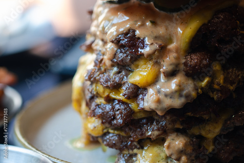 Close up shot of big beef burger full of fresh beef and sauce photo