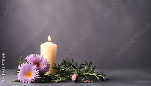 Beautiful purple aster flower and burning candle on dark background.