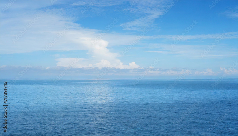 Tranquil Seascape under a Clear Blue Sky with Fluffy Clouds on a Sunny Summer Day