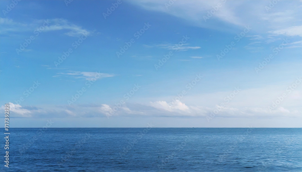 Tranquil Seascape under a Clear Blue Sky with Fluffy Clouds on a Sunny Summer Day