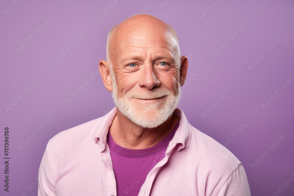 Portrait of a senior man with white beard on a purple background. Portrait of a senior man with white beard on a purple background.