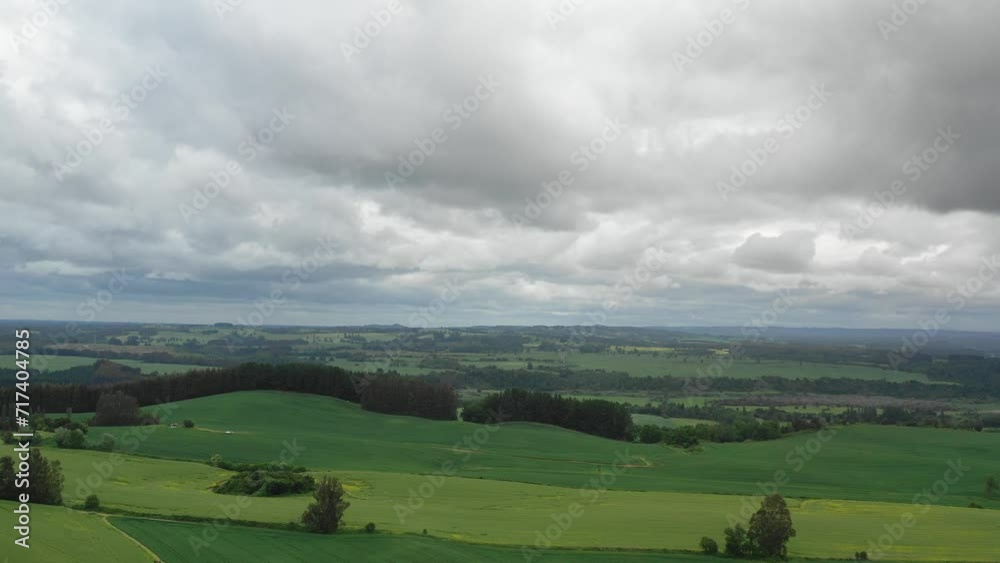 Time Lapse Aerial view green agricultural field cloudy spring day drone flying Time Lapse Aerial view green agricultural field cloudy spring day drone flying