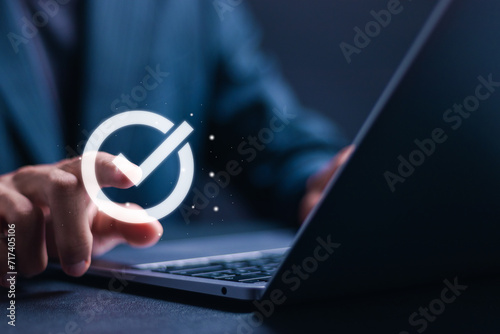 Fotografi Businessman use laptop with virtual correct mark to approve document for service guarantee, business process, quality assurance management, certification
