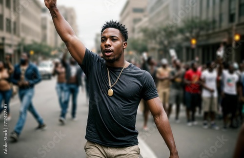 an African American protester in a protest with a group of protesters in a street calling for social justice