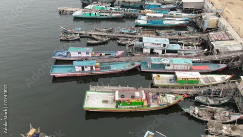 Aerial footage of boats docked at the pier in a slum and densely populated area in Cilingcing, Tanjung Priok, North Jakarta | Perahu kayu bersandar di Dermaga Wilayah kumuh padat penduduk 4K Drone photo