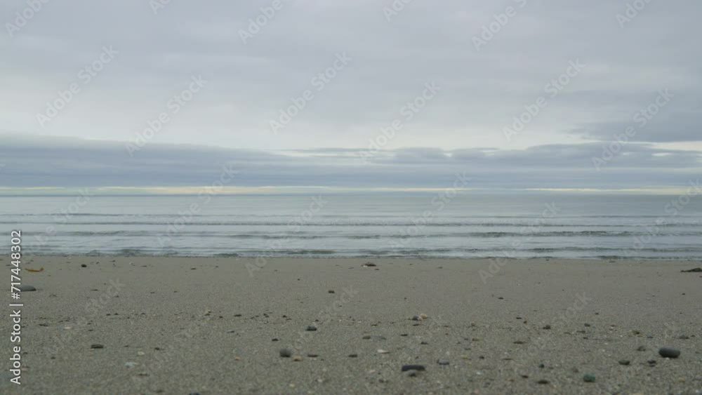 Ocean sea shore waves in slow motion muddy cloudy gray sky horizon line Ocean sea shore waves in slow motion muddy cloudy gray sky horizon line