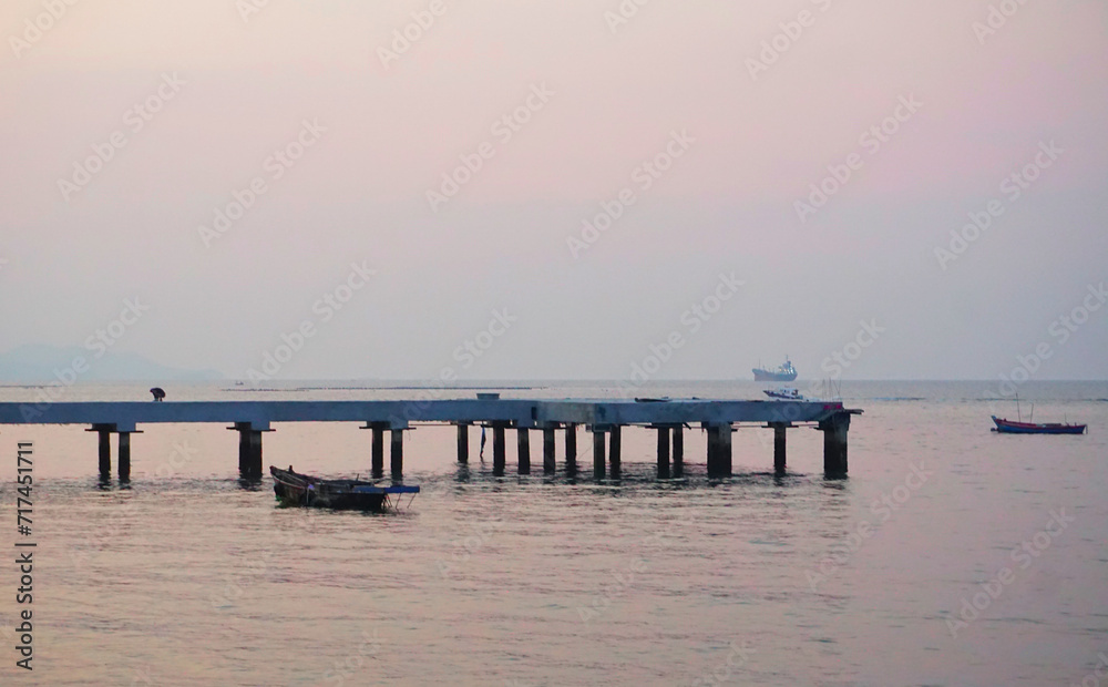 Small boat mooring at jetty with twilight sky