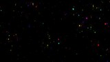 Colorful glitter particles on plain black background