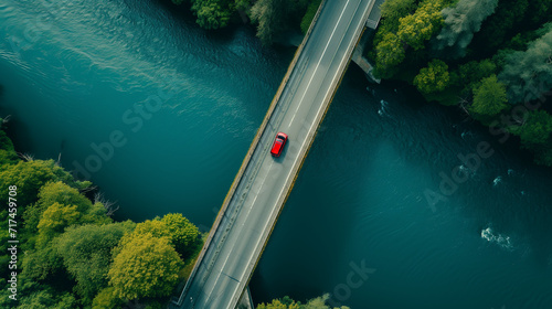 Aerial View of Car Driving on River Bridge photo