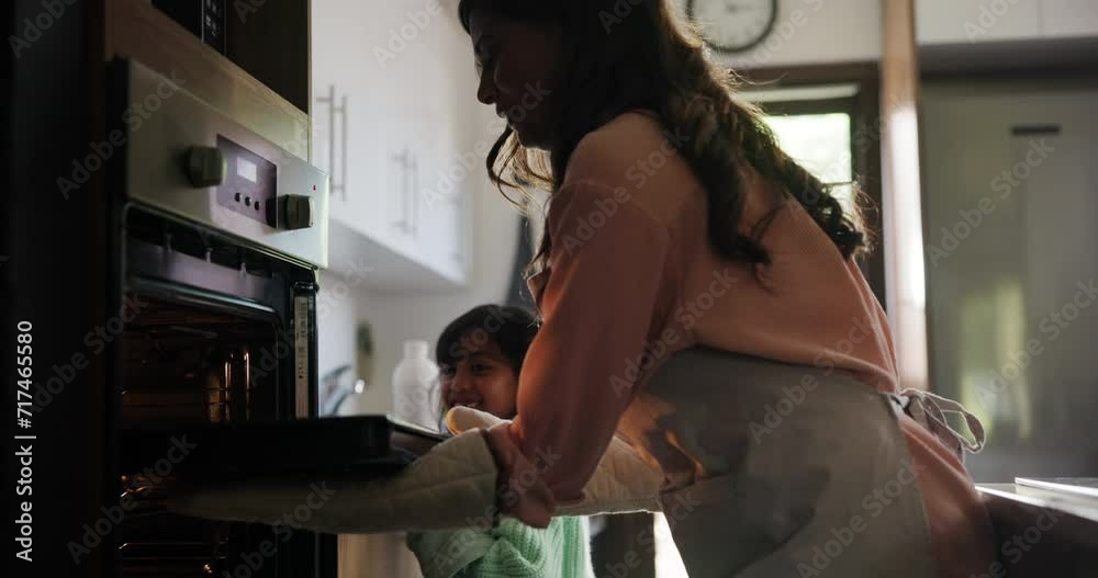 Child, learning and mom cooking in oven with food or cookies on tray in kitchen. Mother, teaching and baking with kid excited to help in home and show girl meal prep process and bonding together