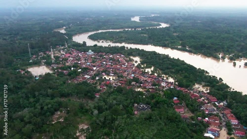 Aerial footage of villages and residents houses being submerged by overflowing rivers which resulted in flooding in Musi Rawas Utara, South Sumatra, Indonesia 4K Drone Video | Banjir Musi Rawas Utara photo