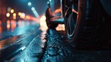 A closeup of a cars tire gripping the pavement leaving behind a trail of blurred skid marks as it accelerates into the night.