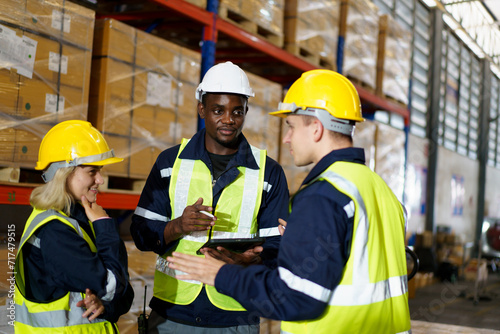 Diversity ethnicity of warehouse staffs or engineers making a discussion together before start working.