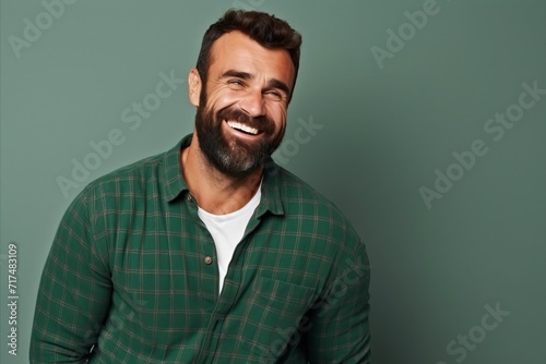 Portrait of a handsome smiling man in a green checkered shirt