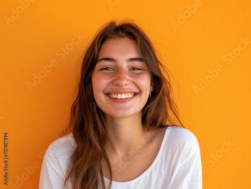 Portrait of a Cheerful Young Woman on Orange Backdrop. Generative AI.