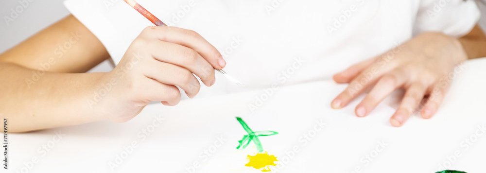 Child girl painting draws are engaged in creativity in kindergarten Child girl painting draws are engaged in creativity in kindergarten