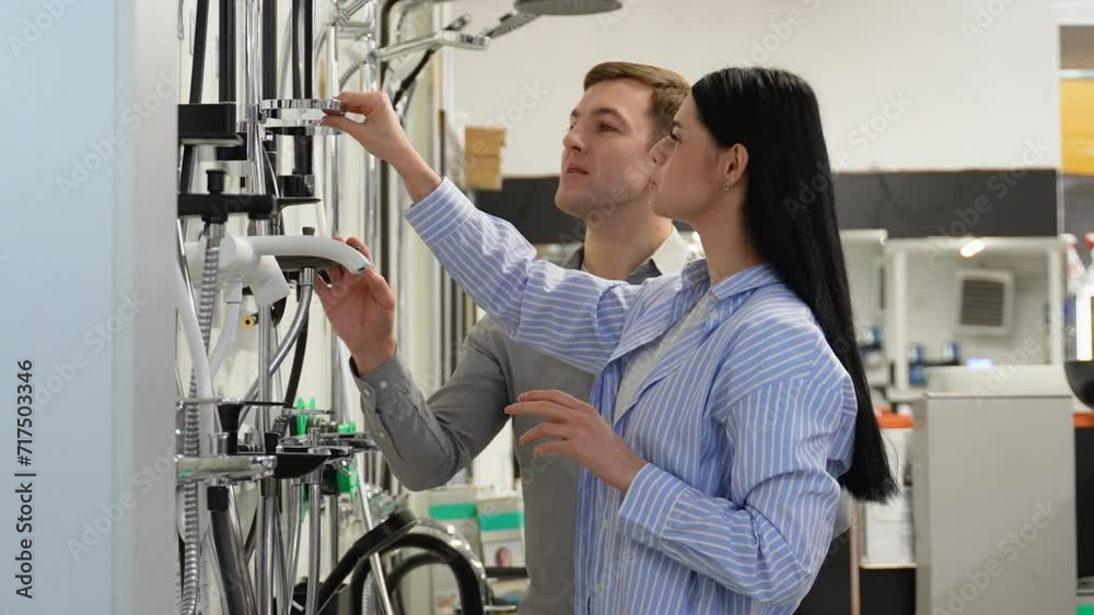 Couple shopping for bathroom equipment in hardware store Couple shopping for bathroom equipment in hardware store