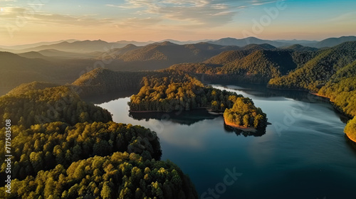 Beautiful landscape of green mountains and lake in the morning with sunrise sky. Nature landscape. Watershed forest. Water and forest sustainability concept. Aerial view of mountain with green trees photo