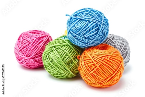Five colorful cotton thread balls isolated on a white background in orange pink grey green and blue