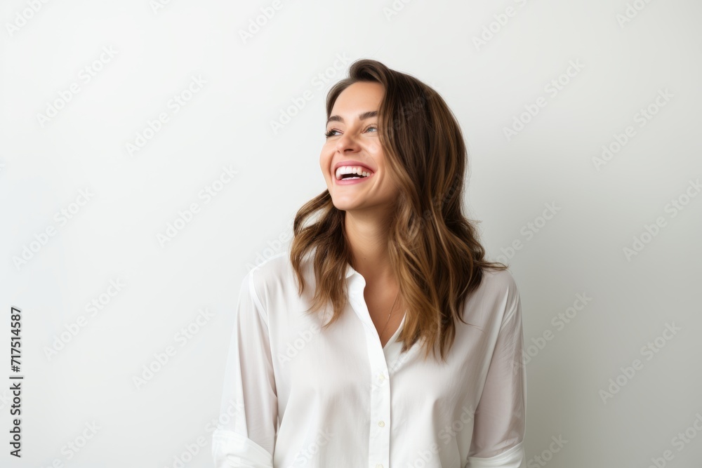 Portrait of a happy young woman laughing, isolated on white background Portrait of a happy young woman laughing, isolated on white background