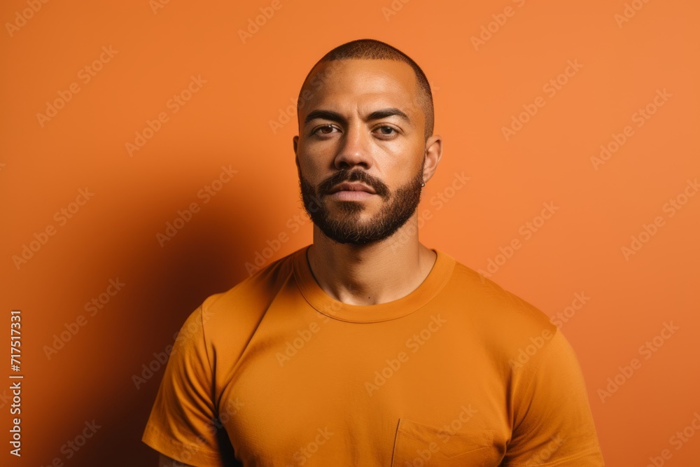 Portrait of a handsome young man in orange t-shirt on orange background Portrait of a handsome young man in orange t-shirt on orange background