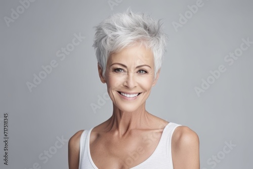 Portrait of a happy senior woman with short grey hair and beautiful smile
