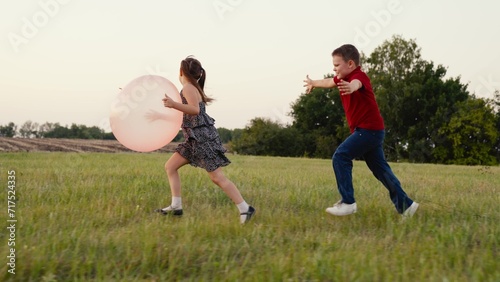 girl boy child running into sunset with ball hands, children running lawn, happy family dream, peace remains a spacious playground of hope, mood sky above them, innocence purest form happiness, child