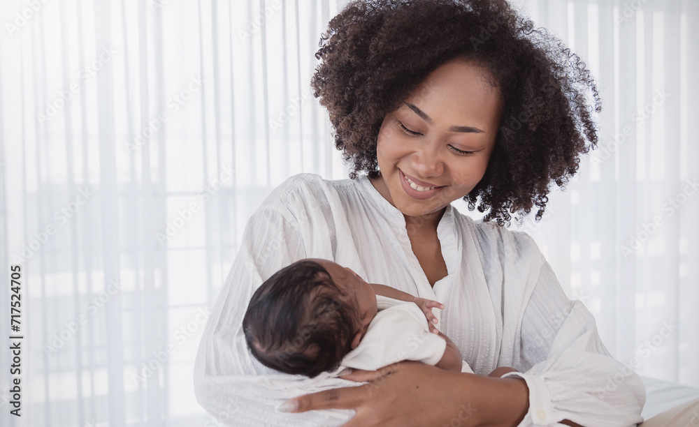 Close up portrait of beautiful young African American mother holding sleep newborn baby in hospital bed room. Healthcare medical love black afro woman lifestyle mother's day, breast with copy space. Close up portrait of beautiful young African American mother holding sleep newborn baby in hospital bed room. Healthcare medical love black afro woman lifestyle mother's day, breast with copy space.
