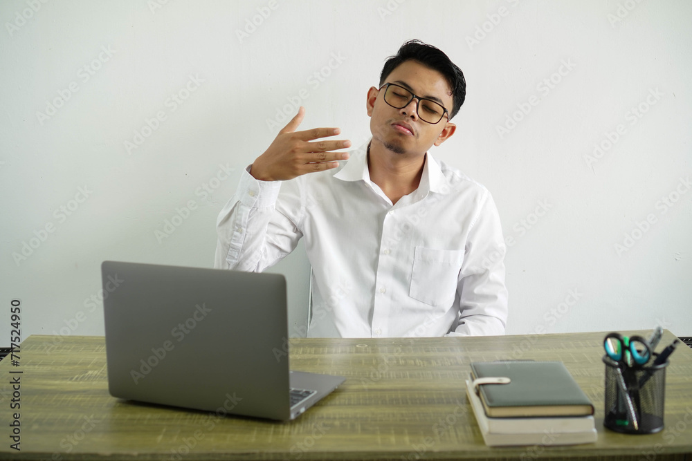 young asian businessman in a workplace with tired and sick expression, wear white shirt with glasses isolated young asian businessman in a workplace with tired and sick expression, wear white shirt with glasses isolated