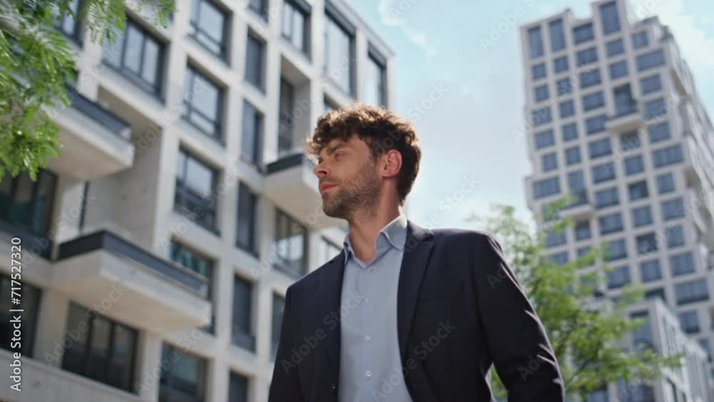 Confident businessman going street in suit closeup. Bearded man walking downtown Confident businessman going street in suit closeup. Bearded man walking downtown