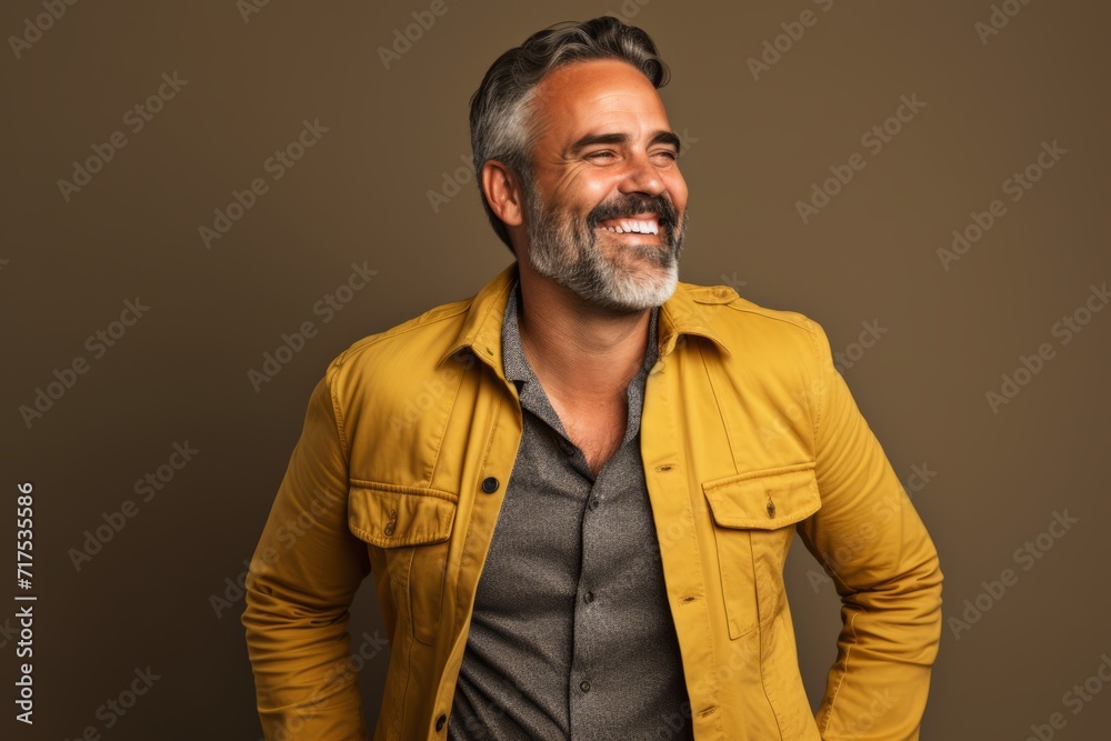 Portrait of a handsome middle-aged man in a yellow jacket. Portrait of a handsome middle-aged man in a yellow jacket.
