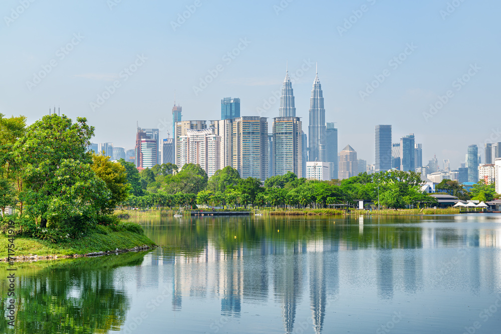 Kuala Lumpur skyline. Scenic lake in a city park