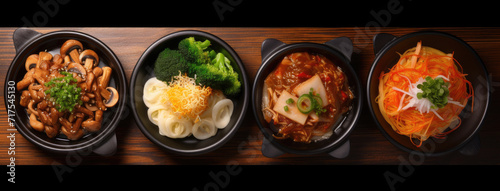 Top view of korean food with vegetables in black bowls on black background. Cooked asian ingredients on a wood serving platter. Generative AI. photo