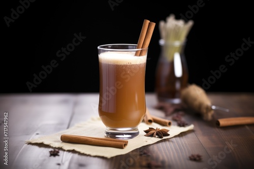 dunkelweizen in a weizen glass, cloudy brown, garnished with a cinnamon stick photo