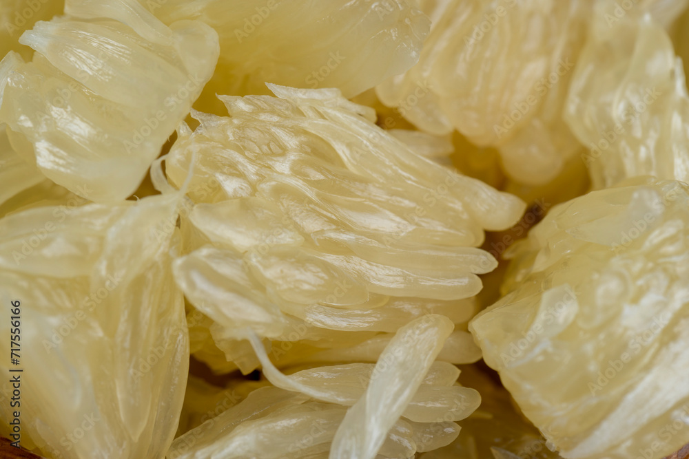 peeled pomelo on the table, close up