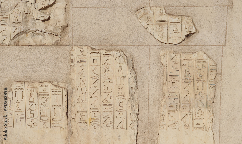 Obraz premium Ancient egyptian hieroglyphics carved on walls of Satet temple on Elephantine island in Aswan, Egypt