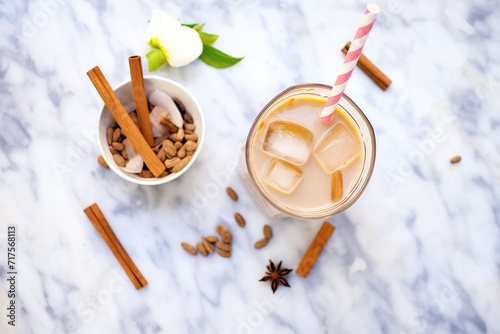 top view of iced chai latte with cinnamon stick garnish