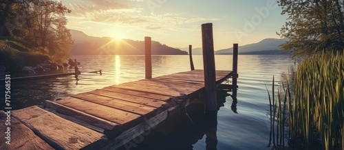 landscape of a lake at sunset and with a wooden jetty. Copy space image. Place for adding text or design #717568531