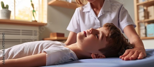 osteopath does physiological and emotional therapy for kid pediatric osteopathy treatment session alternative medicine taking care of the child s health. Copy space image photo