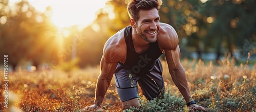 Functional training stretching challenge A man smiles cardio workout A sporty man in sportswear is engaged in fitness in the city Uses a fitness watch and an app. Copy space image photo