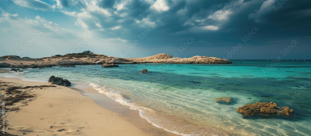 Obraz premium Nissi Beach in Ayia Napa clean aerial photo of famous tourist beach in Cyprus the place is a known destination on island and is formed from a smaller island just near the main shore. Copy space image