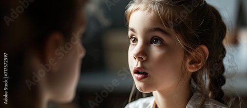 Girl learning to speak in presence of her speech therapist. Copy space image. Place for adding text or design