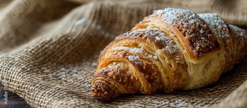 Mexican Cuernito Bread Sugar Croissant on Woven Tablecloth. Copy space image. Place for adding text or design photo