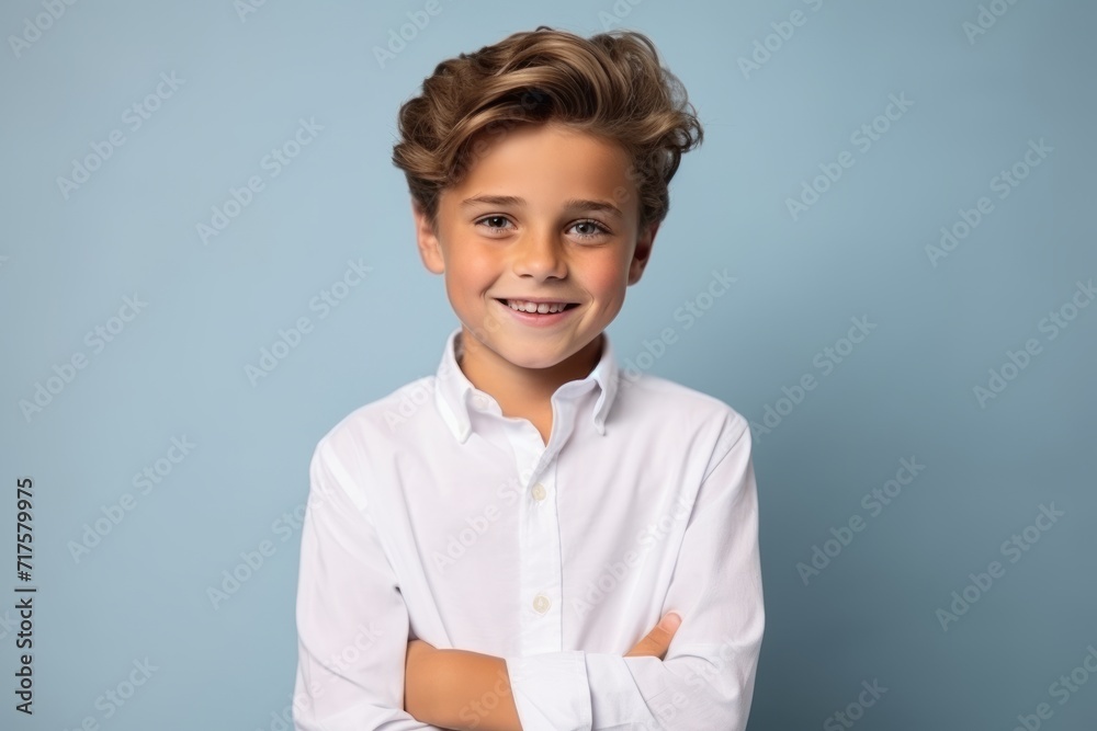 Portrait of a little boy in a white shirt on a blue background Portrait of a little boy in a white shirt on a blue background