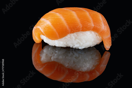 Composition of fresh salmon sashimi sushi isolated on a black background with reflect.A healthy delicacy.