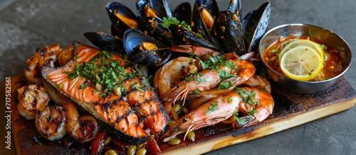 Mixed seafood platter includes mussels, prawns, salmon, calamari, and grilled barracuda with spicy garlic chili sauce.