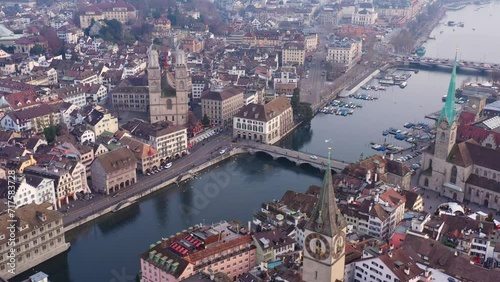 Zurich, Switzerland: Aerial drone footage Zurich old town city center along the Limmat river with the Grossmunster cathedral in Switzerland largest city.  photo
