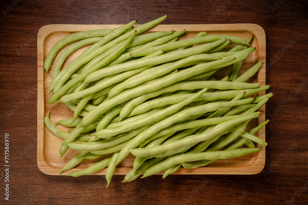 Green bean or Green pea in wooden plate on wooden background, French Bean or Green bean in wooden basket on wooden table. Green bean or Green pea in wooden plate on wooden background, French Bean or Green bean in wooden basket on wooden table.